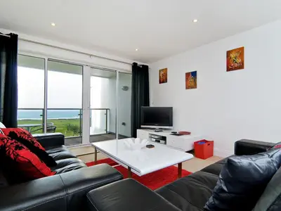a living room with a couch and a table at 28 Bredon Court in Newquay