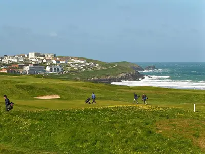 people walking on a golf course near the ocean at 28 Bredon Court in Newquay