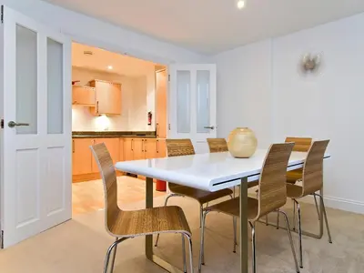 a kitchen and dining room with a table and chairs at 28 Bredon Court in Newquay