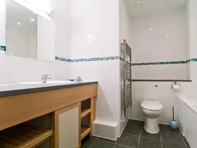 a bathroom with a sink and a toilet and a tub at 28 Bredon Court in Newquay