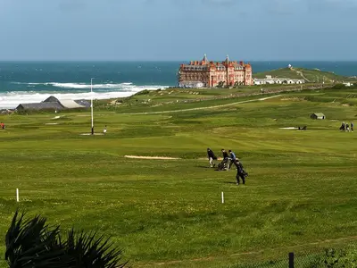 a group of people on a golf course with a castle in the background at 28 Bredon Court in Newquay