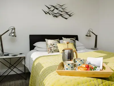 a tray of food on a bed with a tray of food at 50 Bredon Court in Newquay