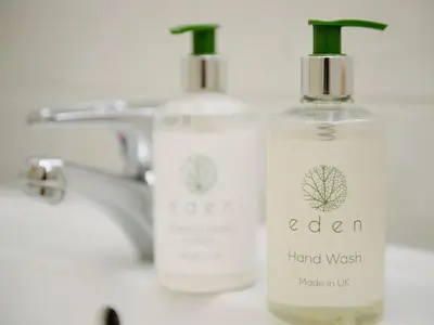 two bottles of soap sitting on a bathroom sink at 50 Bredon Court in Newquay
