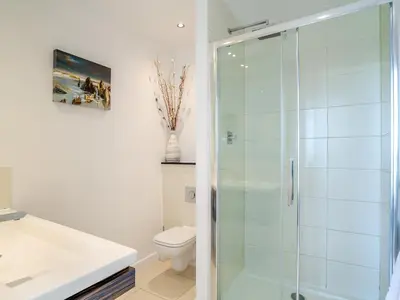 a bathroom with a glass shower and a toilet at 7 Cribbar in Newquay