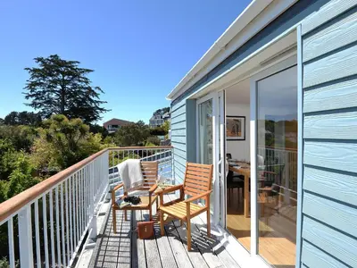 a balcony with two chairs and a table on it at Florizel in Falmouth