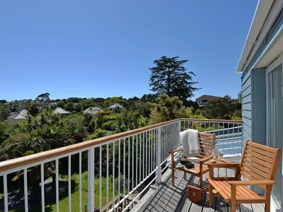 a balcony with two chairs and a view of the ocean at Florizel in Falmouth