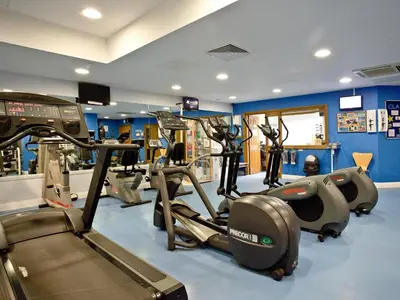 a gym with treadmills and elliptical machines at Holly in Saint Wenn