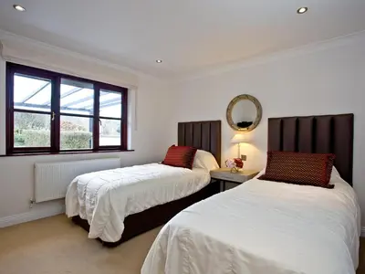 a bedroom with two beds and a mirror on the wall at Holly in Saint Wenn