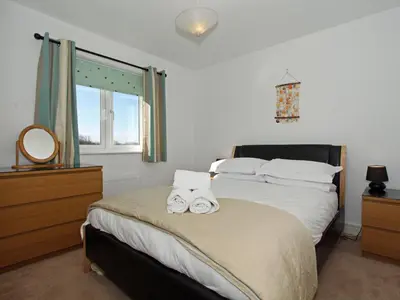 a bedroom with a bed with two towels on it at 6 Jubilee Close in St Merryn