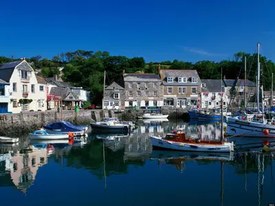 a group of boats docked in a harbor with houses at 6 Jubilee Close in St Merryn