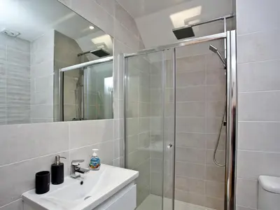 a bathroom with a shower and a sink at Above Towan At 8 Quay Court in Newquay