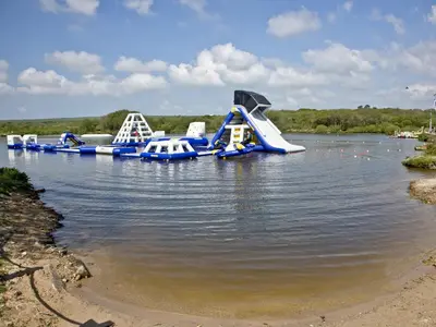 a water park with a slide in the water at Ash Lodge - Retallack in Saint Columb Major
