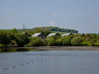 a river with a bunch of buoys in the water at Ash Lodge - Retallack in Saint Columb Major