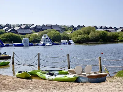 a group of boats parked on the shore of a lake at Ash Lodge - Retallack in Saint Columb Major
