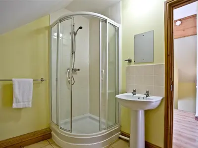 a bathroom with a shower and a sink at Beech Lodge - Retallack Resort in Saint Columb Major