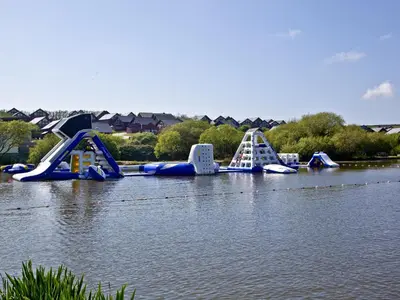 a group of inflatable slides in the water at Beech Lodge - Retallack Resort in Saint Columb Major