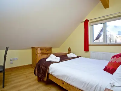 a bedroom with a bed and a window at Beech Lodge - Retallack Resort in Saint Columb Major