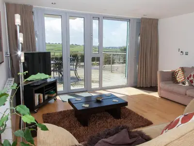 a living room with a couch and a table at 12 Zinc in Newquay