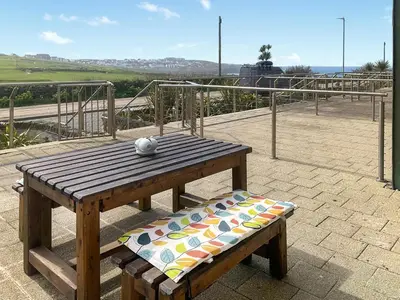 a wooden bench with a pillow on top of a table at 12 Zinc in Newquay