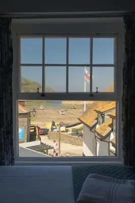 a window with a view of a field from a bedroom at The Slipway B&B in Port Isaac