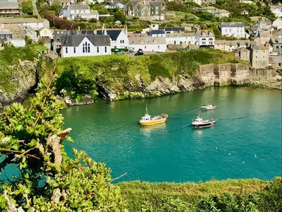 two boats in a river with a town in the background at The Slipway B&B in Port Isaac