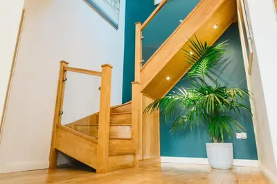 a staircase in a house with a potted plant at Haven Lodge Newquay in Newquay