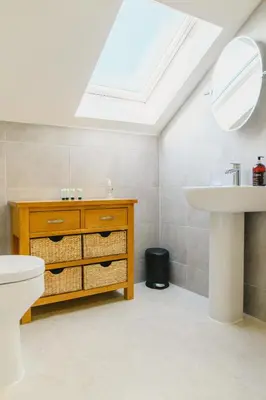 a bathroom with a sink toilet and a skylight at Haven Lodge Newquay in Newquay