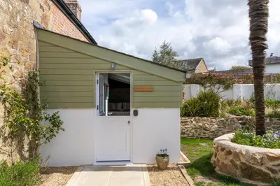 a green and white garage with a white door at Penwyth House in Newquay