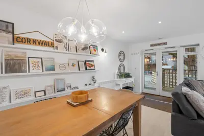 a living room with a table and a couch at Tincroft Cottage - high end, luxury living near the beach in Truro