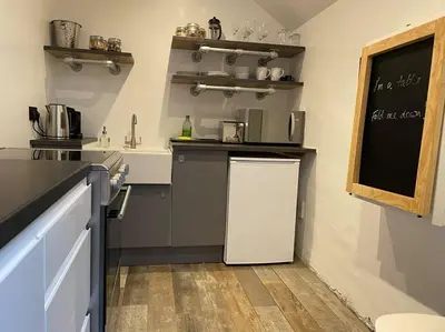 a kitchen with a small refrigerator in a room at An Leti @ Goonwinnow Farm in Newquay