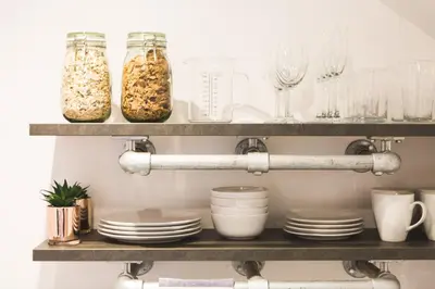 a shelf with glasses and dishes on it at An Leti @ Goonwinnow Farm in Newquay