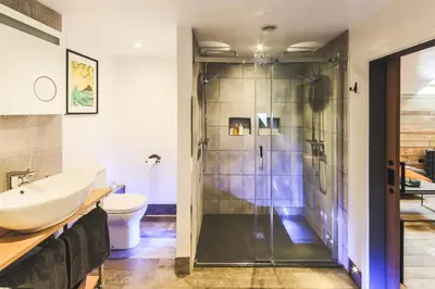 a bathroom with a shower and a toilet and a sink at An Leti @ Goonwinnow Farm in Newquay