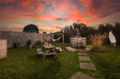 a backyard with a picnic table and a grill at Wheal Rose -Beautifully Fitted Lodge Helston Cornwall in Helston
