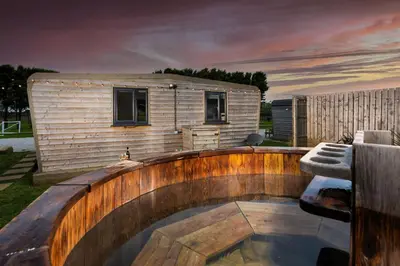 a small backyard with a pool and a tiny house at Wheal Rose -Beautifully Fitted Lodge Helston Cornwall in Helston