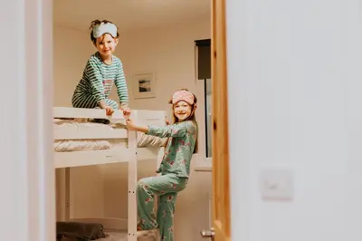 two children in a bunk bed in a room at Wheal Rose -Beautifully Fitted Lodge Helston Cornwall in Helston