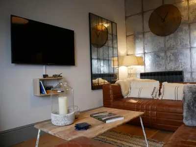 a living room with a couch and a table at Padstow Escapes - Teyr Luxury Penthouse Apartment in Padstow