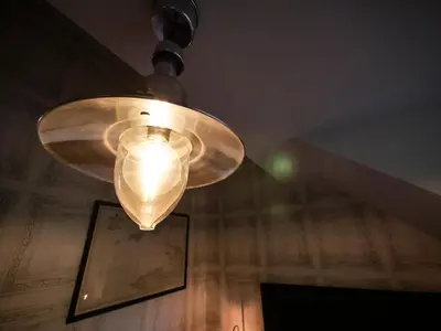 a light hanging from a ceiling in a room at Padstow Escapes - Teyr Luxury Penthouse Apartment in Padstow