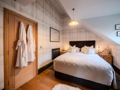 a bedroom with a large bed in a room at Padstow Escapes - Teyr Luxury Penthouse Apartment in Padstow