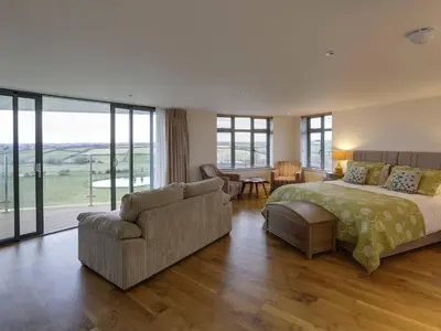 a bedroom with a bed and a couch and a table at The Pickwick Inn & Oliver's Restaurant in Padstow