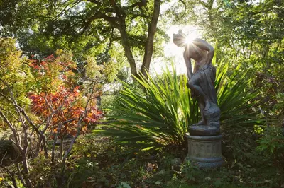 a statue of a woman with the sun shining on at Chycara House in Truro