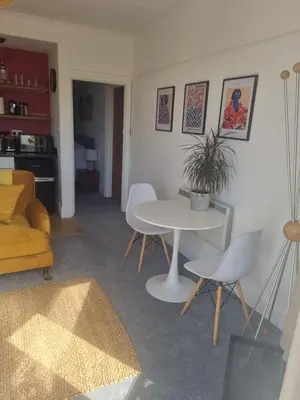 a living room with a white table and chairs at Halwyn Retreat in St Austell