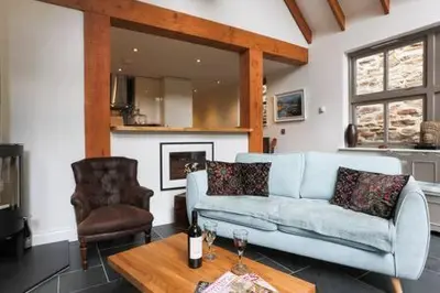 a living room with a couch and a table at The Engine House in Truro