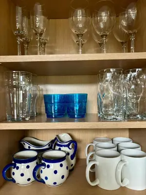 a cupboard filled with lots of glasses and vases at The Engine House in Truro