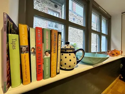 a shelf with a bunch of books on it at The Engine House in Truro