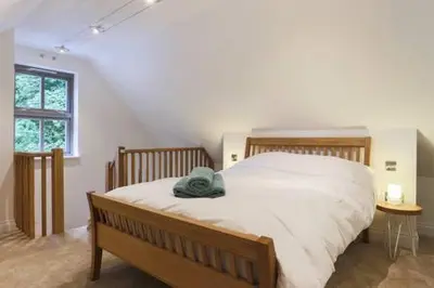 a bedroom with a bed with a blue towel on it at The Engine House in Truro