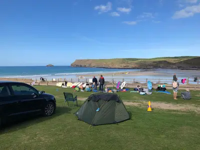 a tent and a car parked at a beach at Westward 14 Polzeath in Polzeath