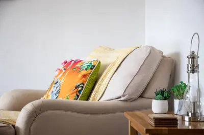 a living room with a couch with a pillow on it at Westward 14 Polzeath in Polzeath