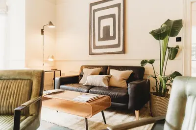 a living room with a couch and a table at Hotel VARA in Truro