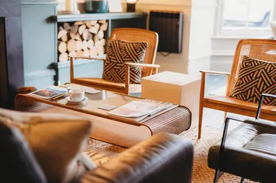 a living room with chairs and a coffee table at Hotel VARA in Truro