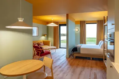 a hotel room with a bed and a table at SeaSpace in Newquay